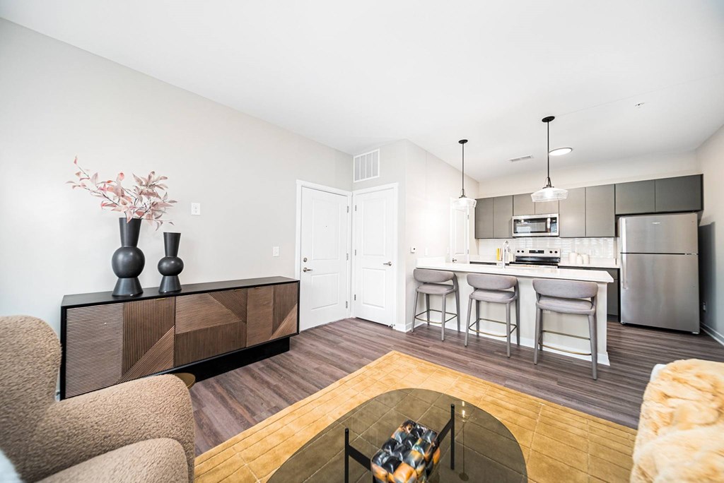 A modern kitchen with a dining area and a living room.