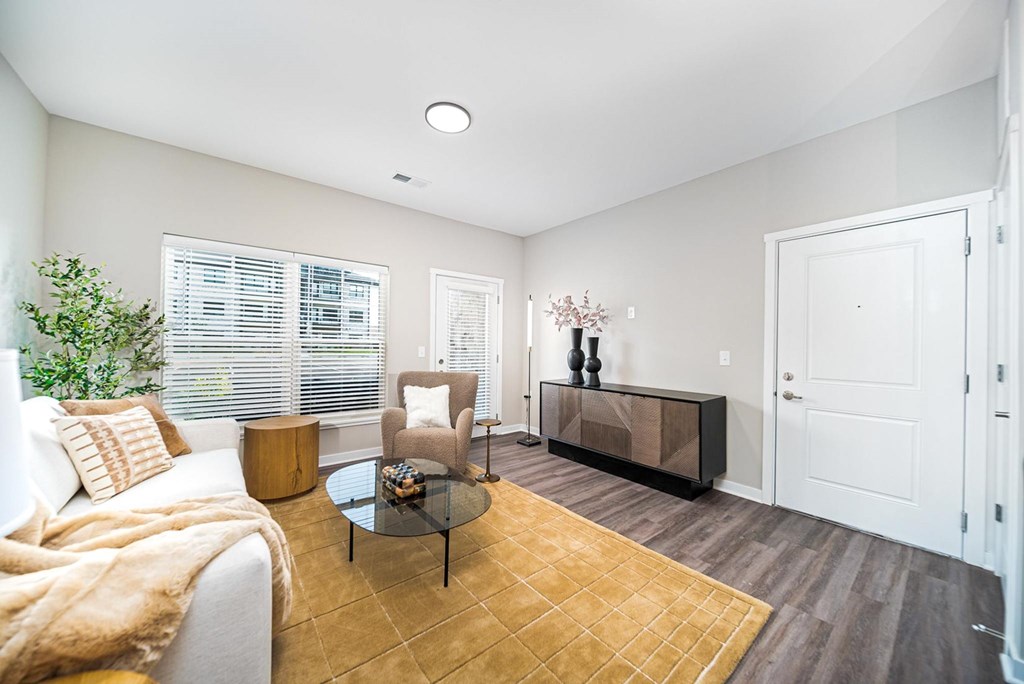 A living room with a couch, chair, and coffee table.