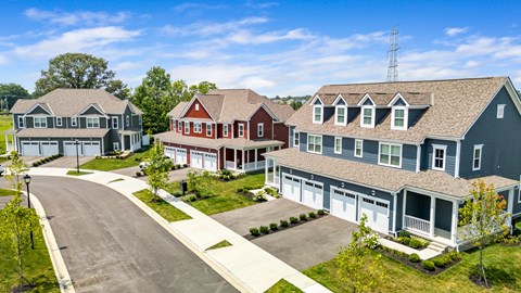 A row of houses with a cell tower in the background.
