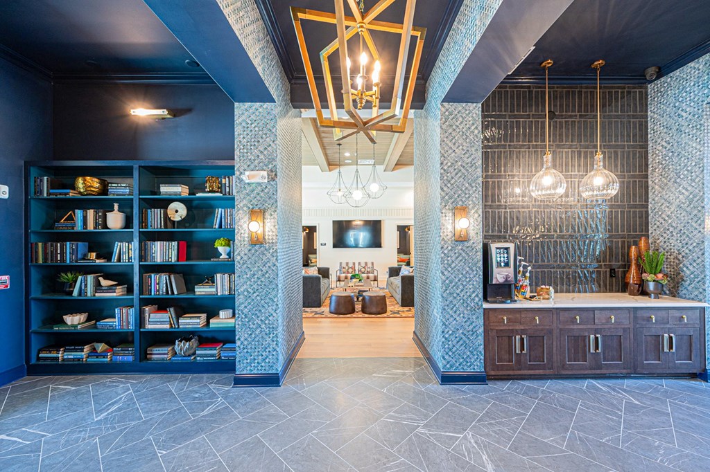 A room with a bookshelf and a counter with a blue tile pattern.