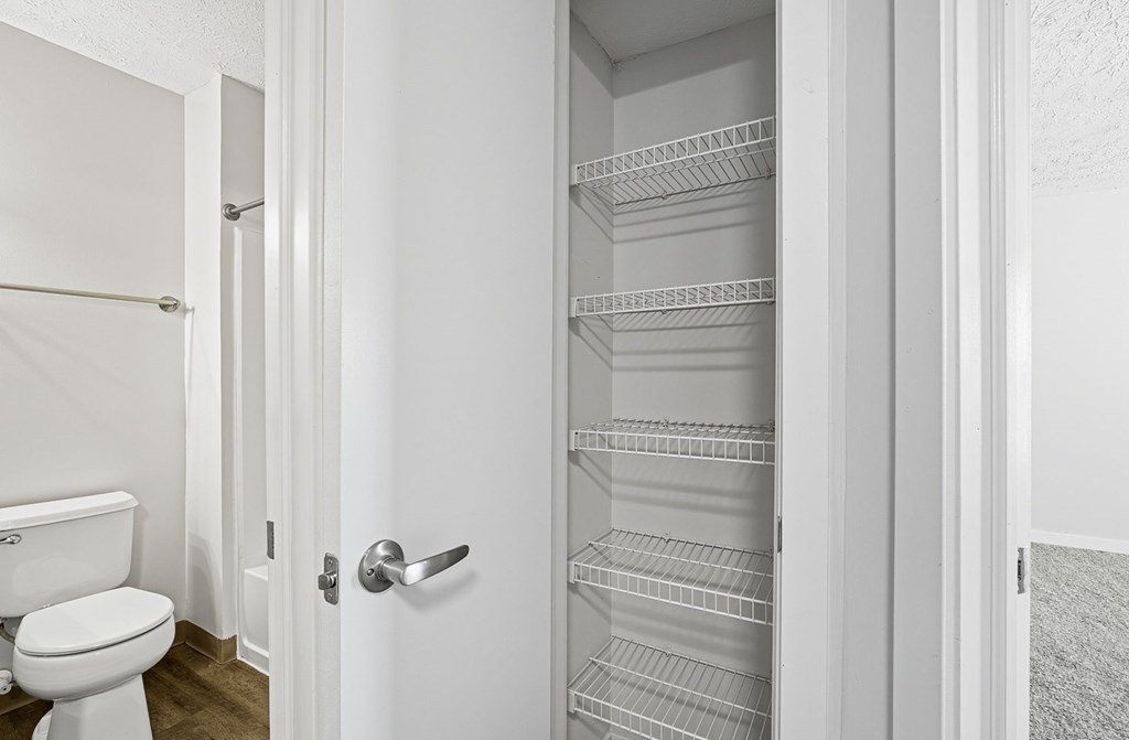 A white door with a handle is open.