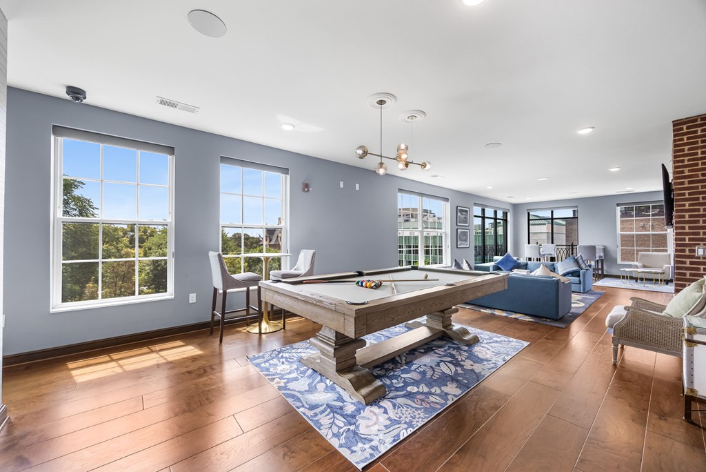 A room with a pool table and a view of the outside.