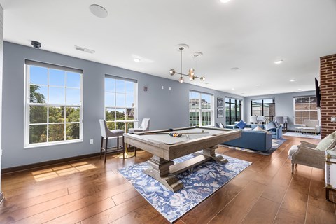 A room with a pool table and a view of the outside.