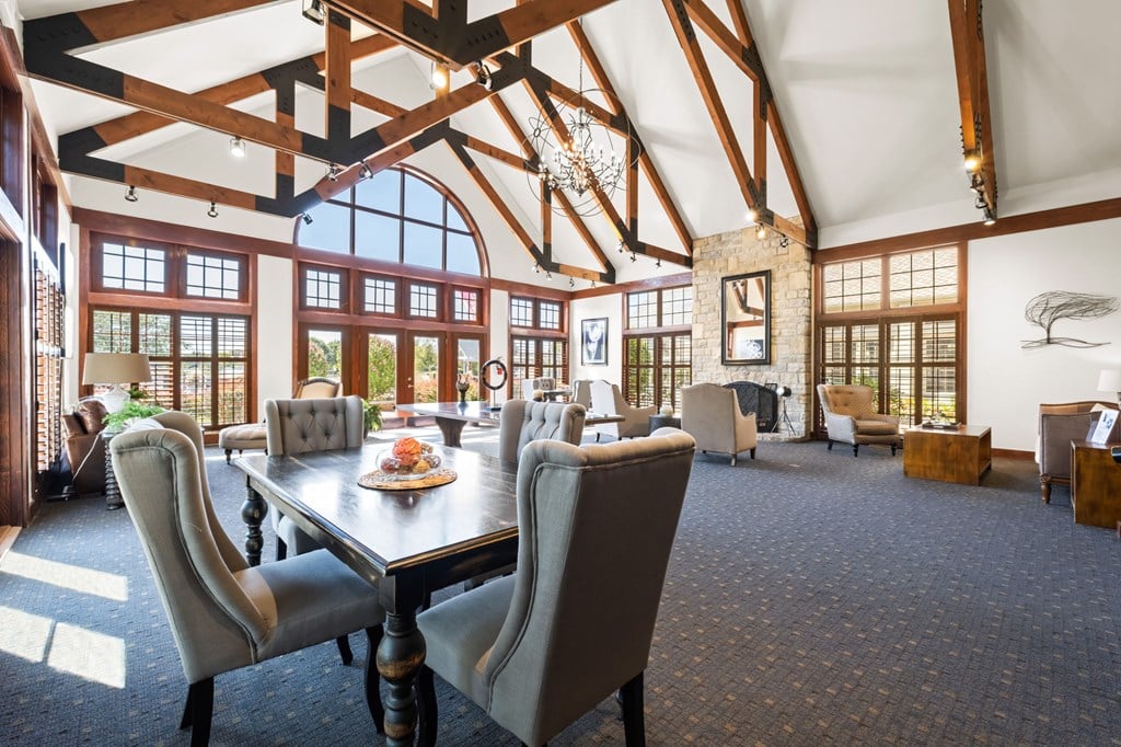 A large dining room with a long table and chairs.