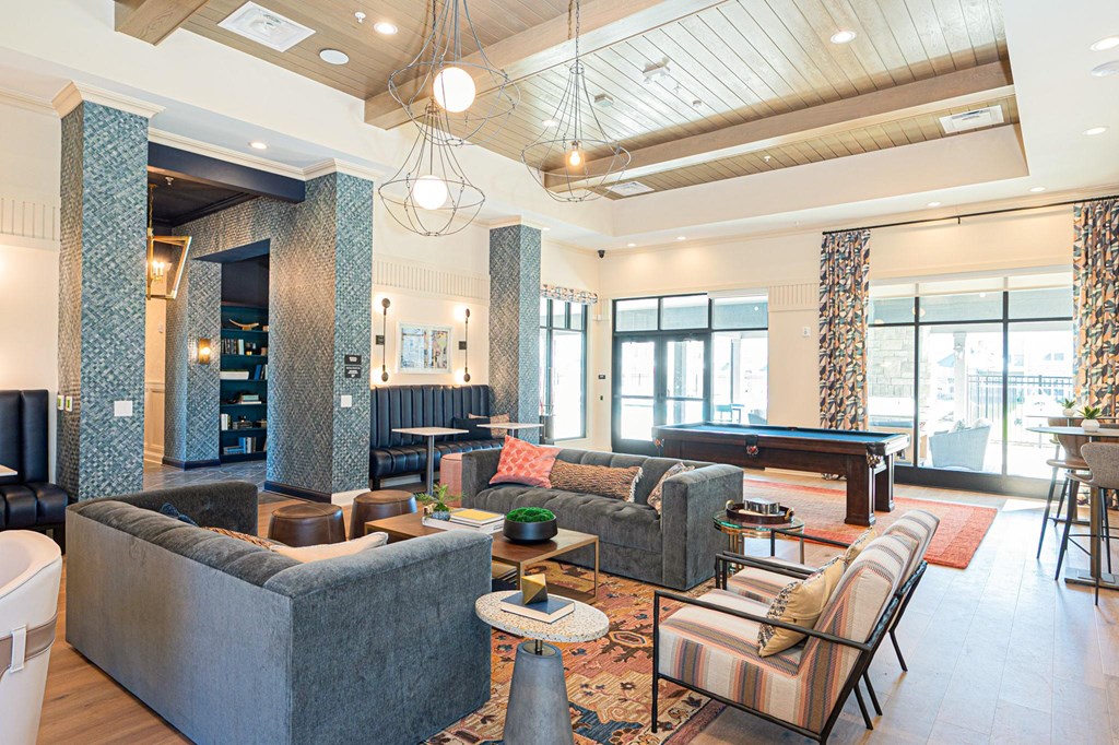A living room with a grey couch and a striped chair.