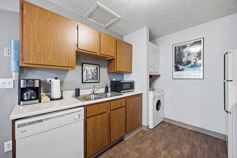 A kitchen with wooden cabinets and white appliances.