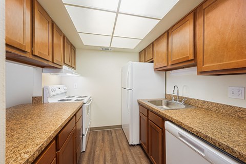 our apartments have a kitchen with granite counter tops and white appliances