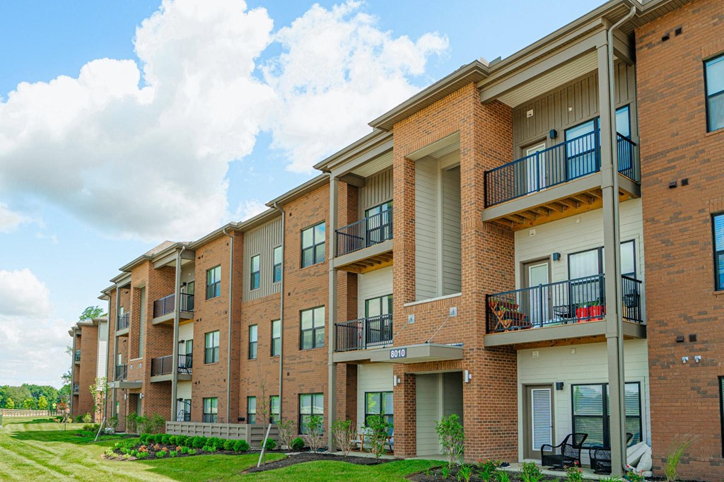 the outlook of a brick apartment building with balconies