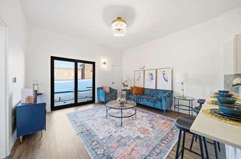 A living room with a blue couch and a coffee table.