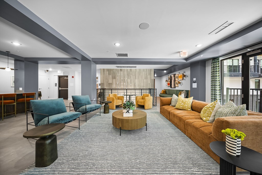 A living room with a blue sofa and a yellow sofa.