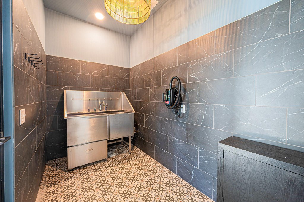A bathroom with a tiled floor and a shower stall.