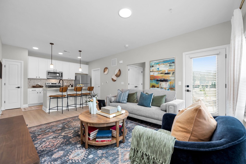 A living room with a white couch and a coffee table.