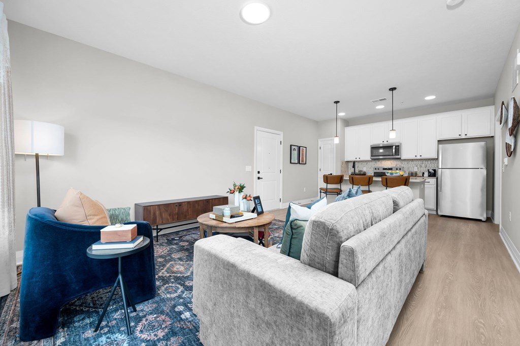 A living room with a grey couch and a blue chair.