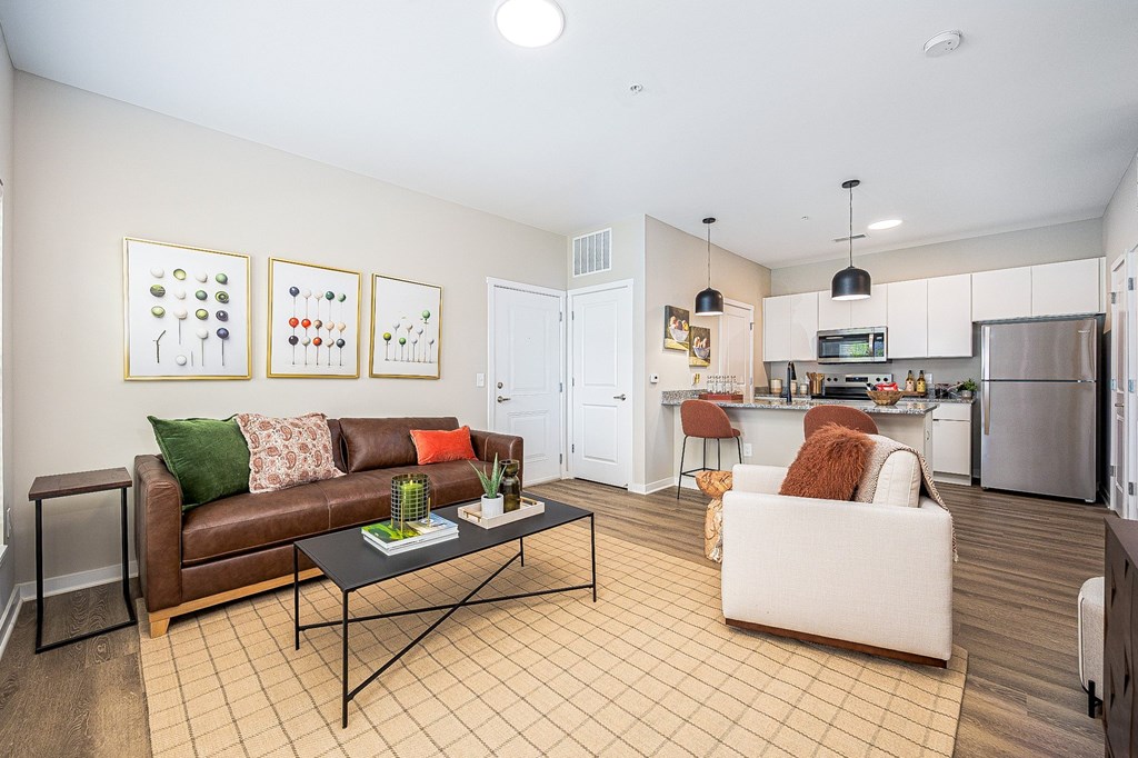 A living room with a brown couch and a white couch.