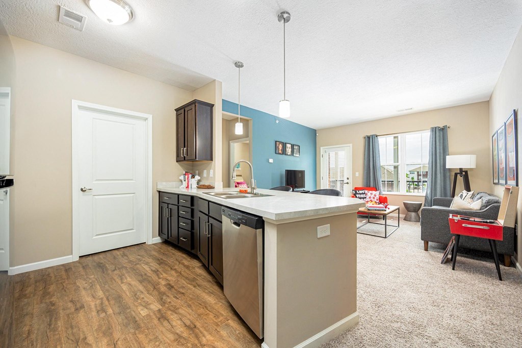 a kitchen and living room with a couch and a table