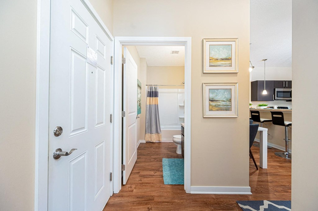 a hallway with a door to a kitchen and a living room