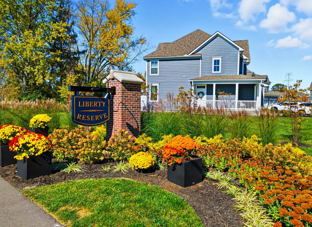 A sign that says "Liberty Reserve" in front of a house.