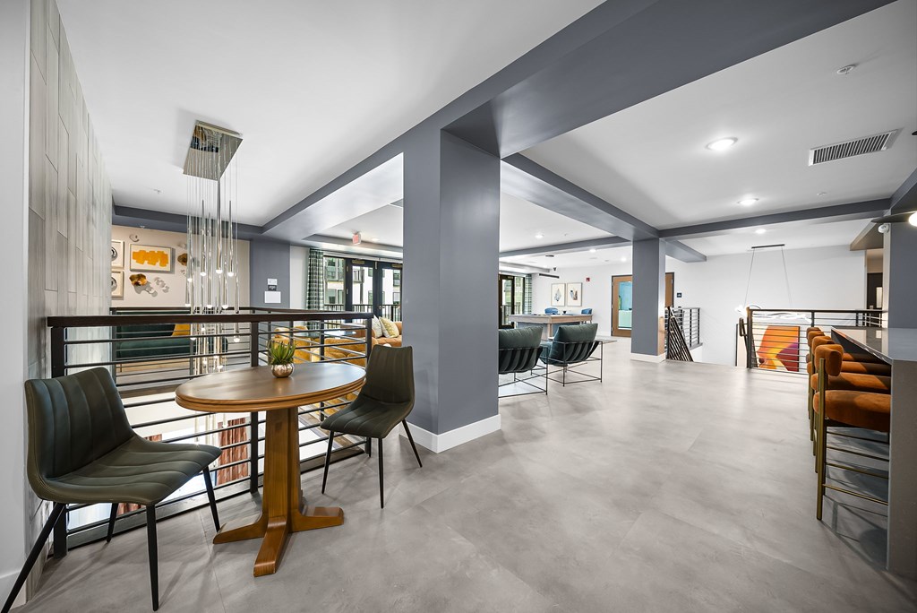A modern dining room with a round wooden table and chairs.