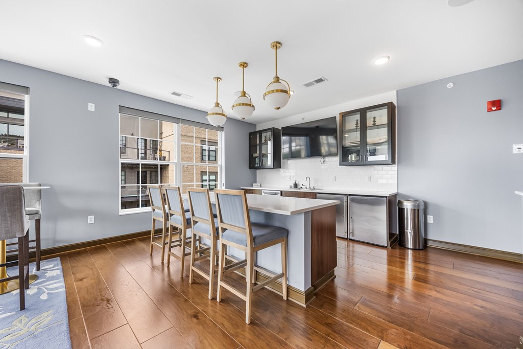 A kitchen with a dining table and chairs.