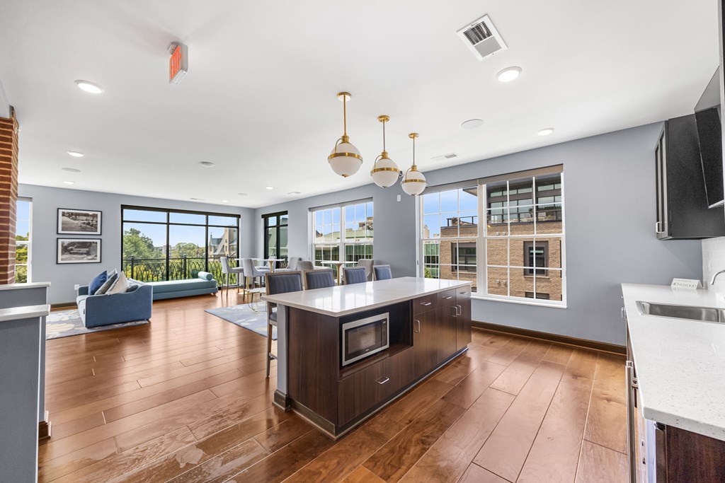 A modern kitchen with a wooden island and stainless steel appliances.