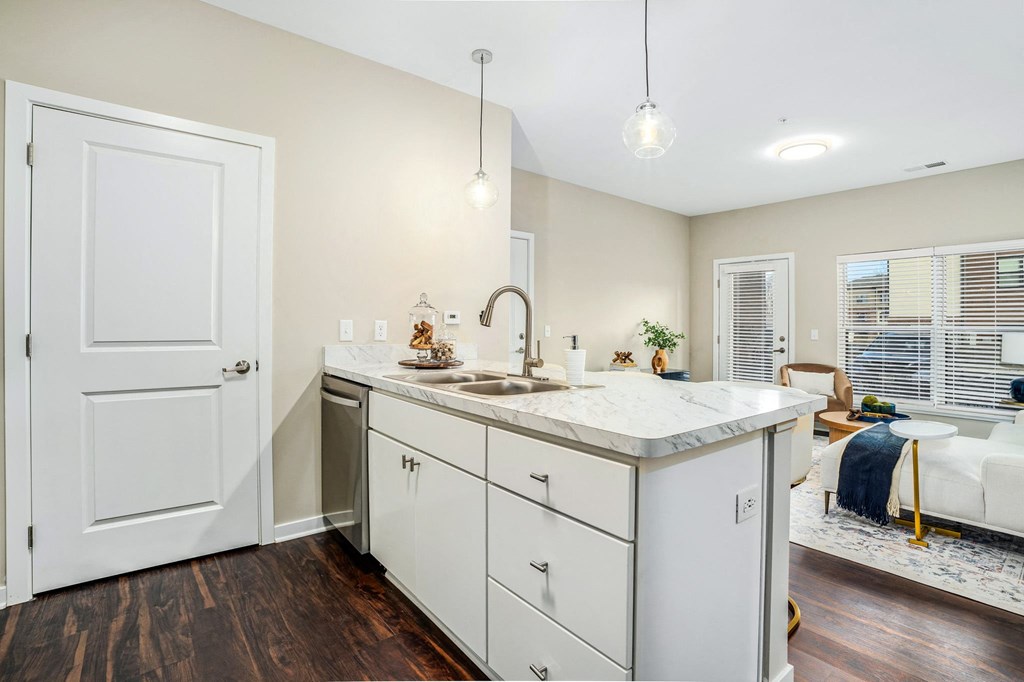 a renovated kitchen with white cabinets and a counter top