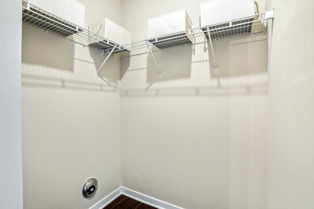 the spacious walk in closet in the master bedroom of a home with a mirrored wall