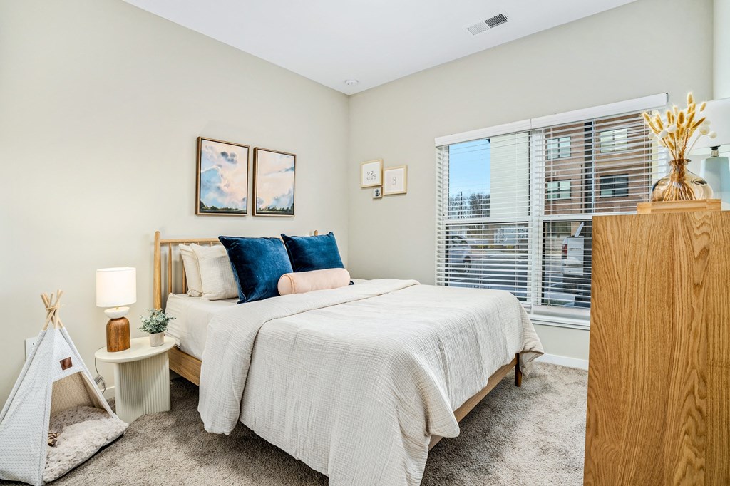 a bedroom with a large bed and a large window