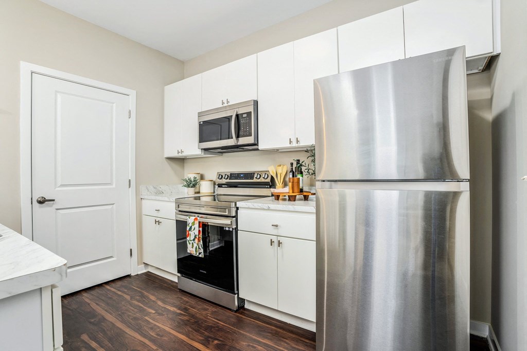 a kitchen with stainless steel appliances and white cabinets