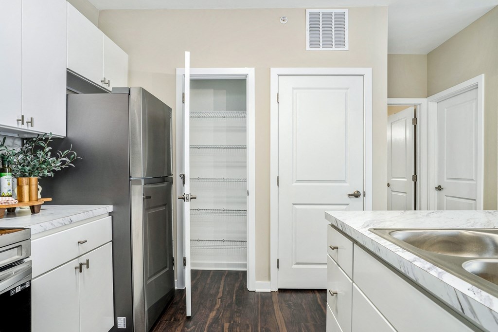 a renovated kitchen with white cabinets and stainless steel appliances