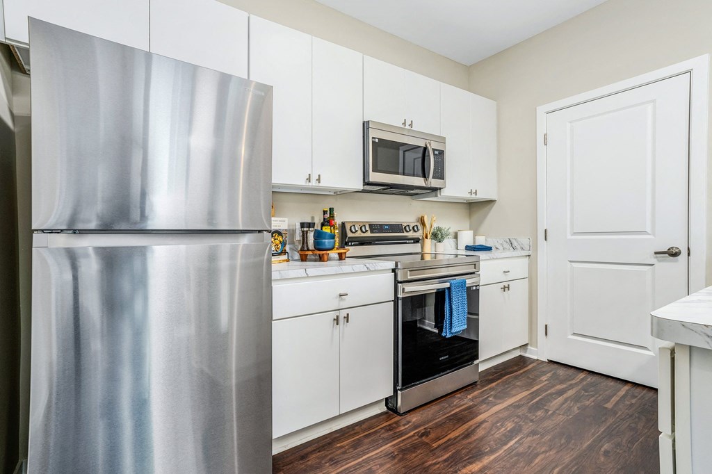 a kitchen with pink and white walls and a stove