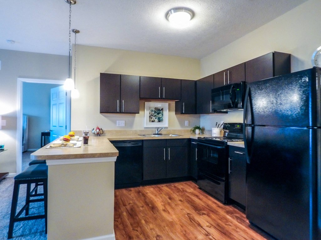 a kitchen with black cabinets and a white island