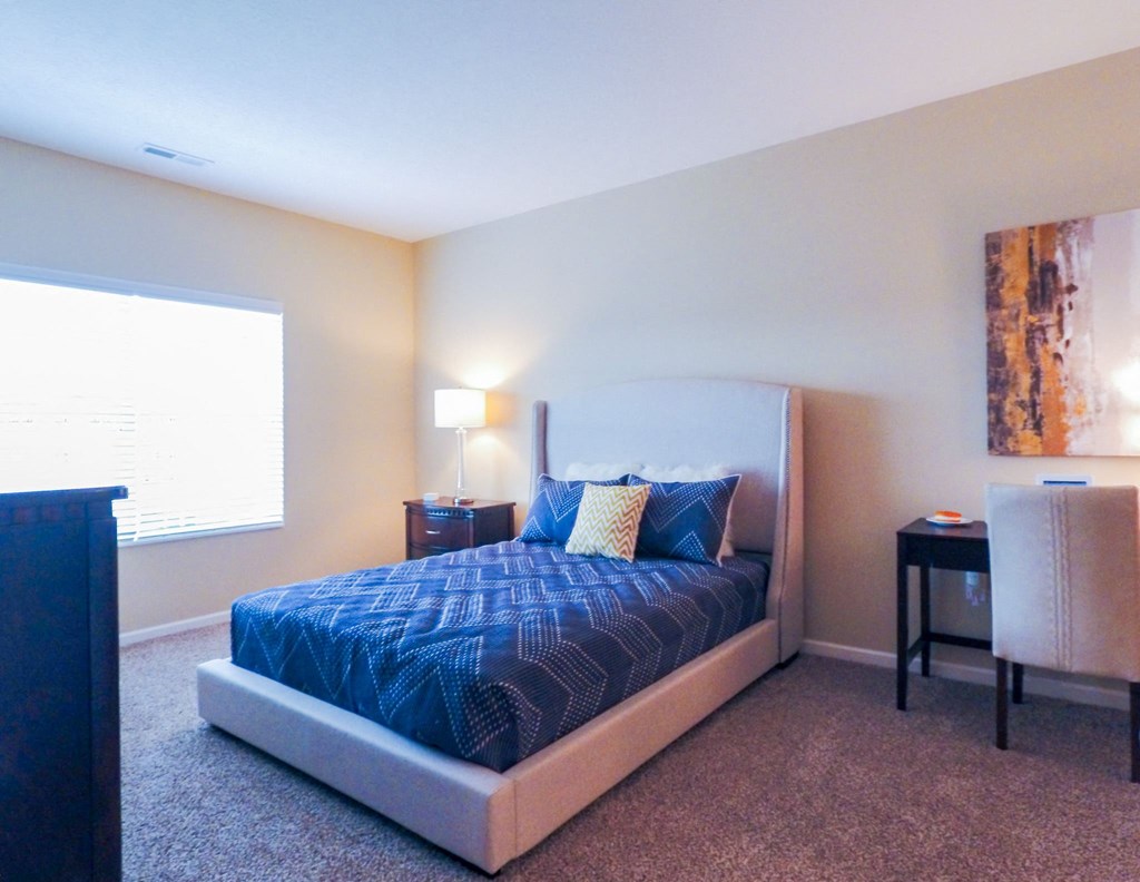 a bedroom with a large bed and a window