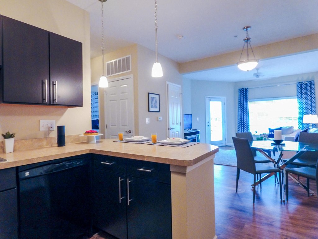 a kitchen with black cabinets and a white counter top