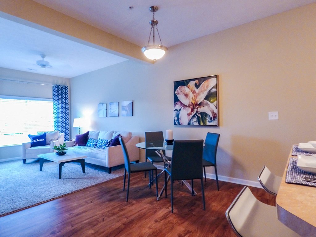 a living room with a couch and a table with chairs