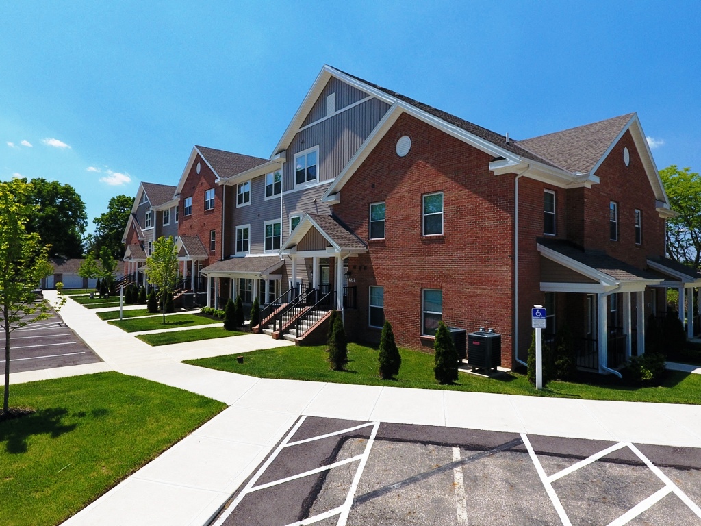 a row of brick apartment buildings on a sunny day