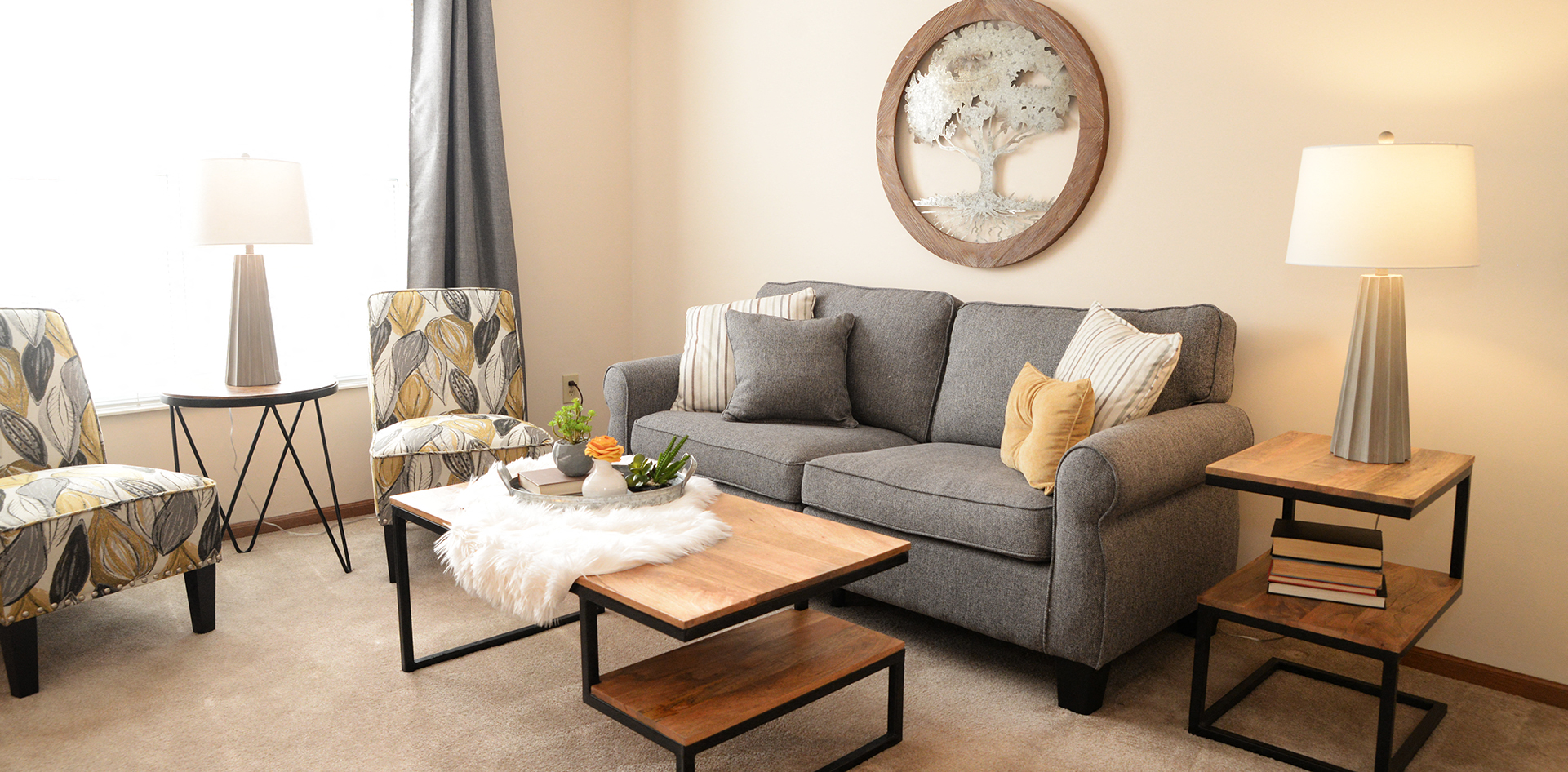 a living room with a couch and chairs and a coffee table