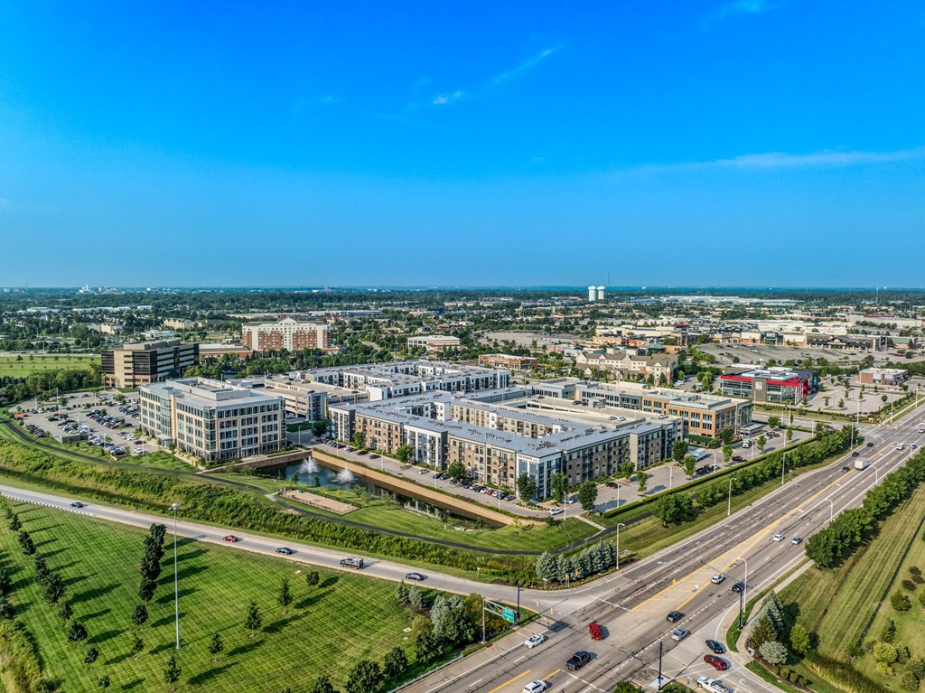 an aerial view of a city with buildings and a highway
