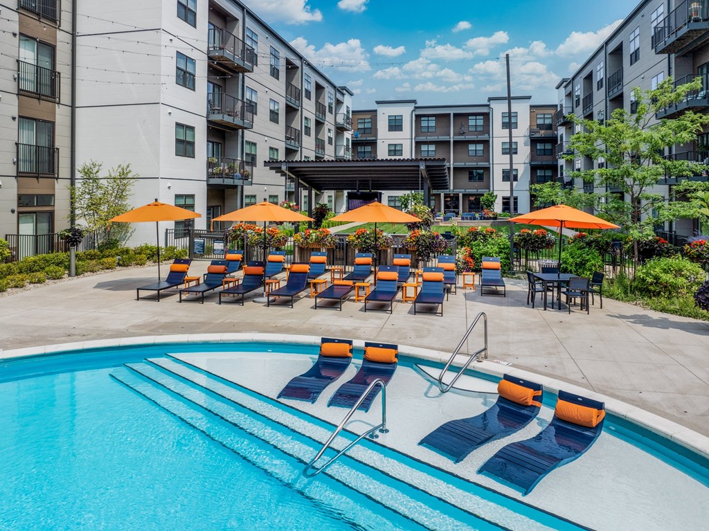 our apartments have a large pool with chairs and umbrellas