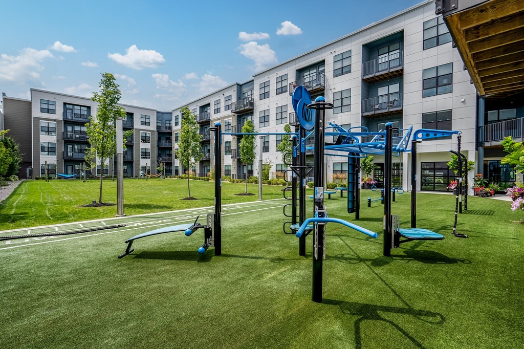 a playground in front of an apartment building