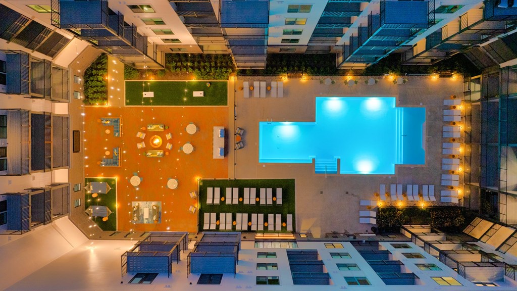 A modern building with a green and orange wall and a blue light.