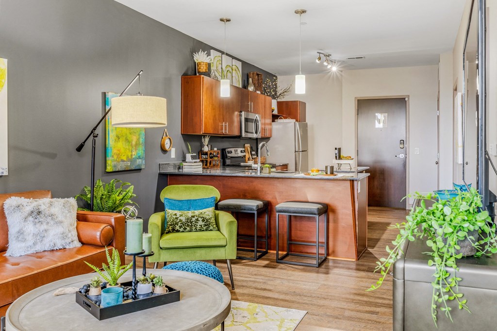 a living room with a kitchen in the background