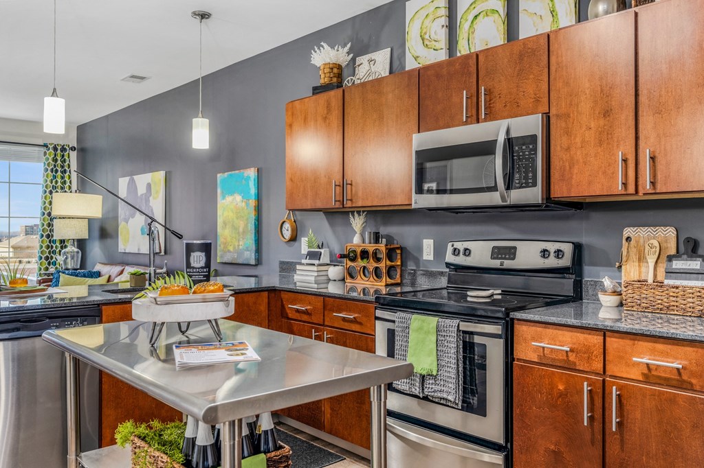 a kitchen with stainless steel appliances and wooden cabinets