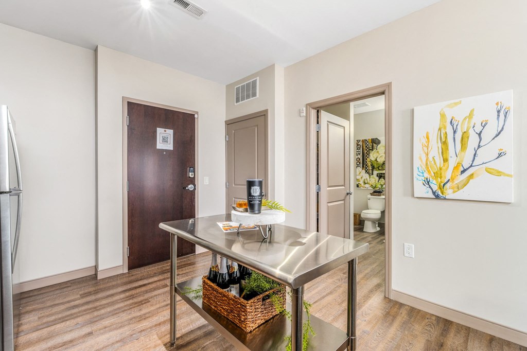 a kitchen with a table and a door to a bathroom