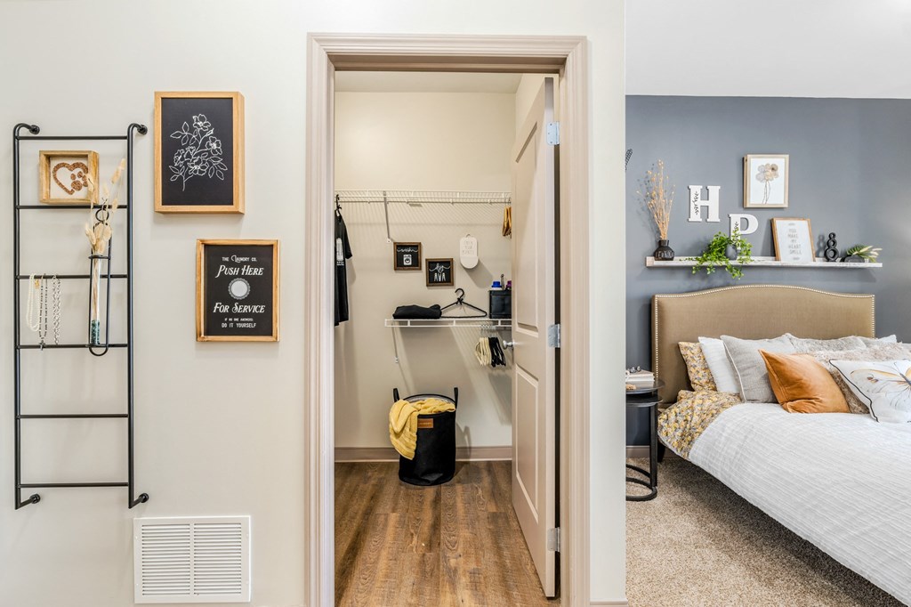 a bedroom with a bed and a closet with shelves and a door to it