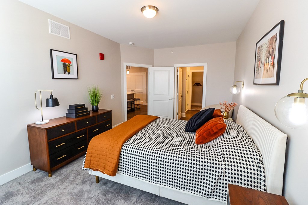 a bedroom with a bed and dresser