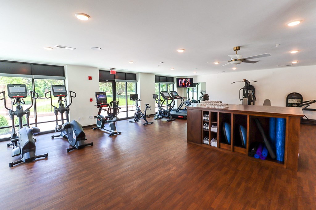 a room with a lot of exercise equipment and a counter