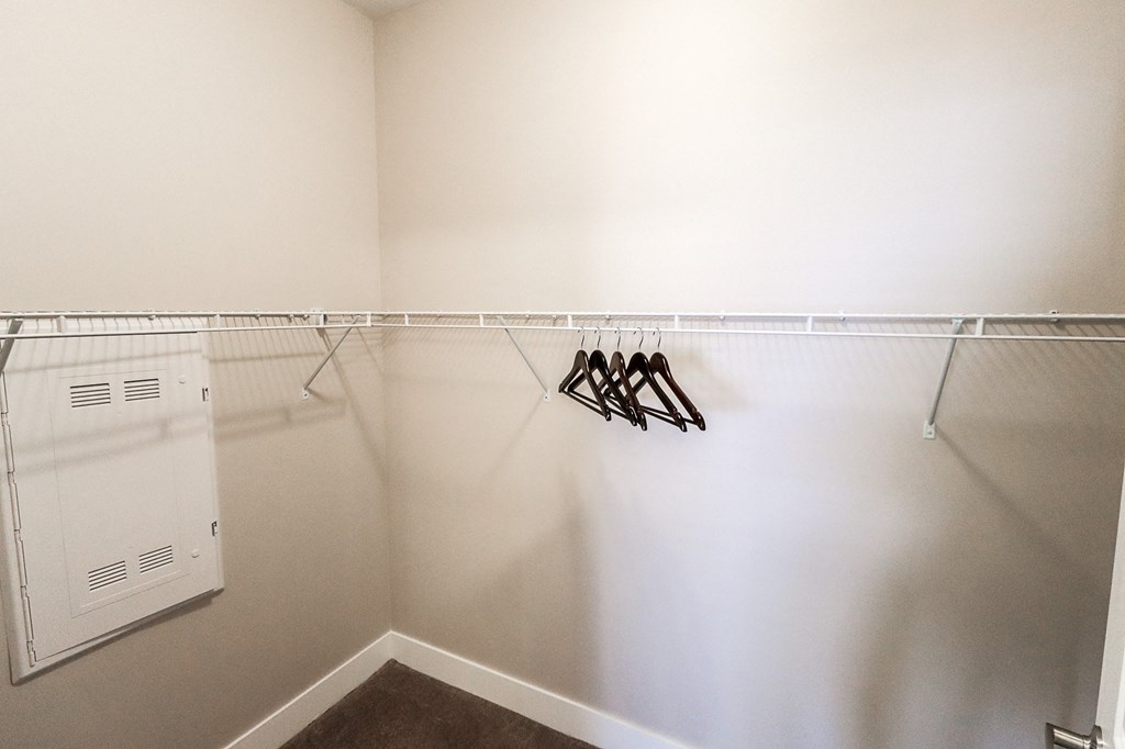 a walk in closet in a bedroom