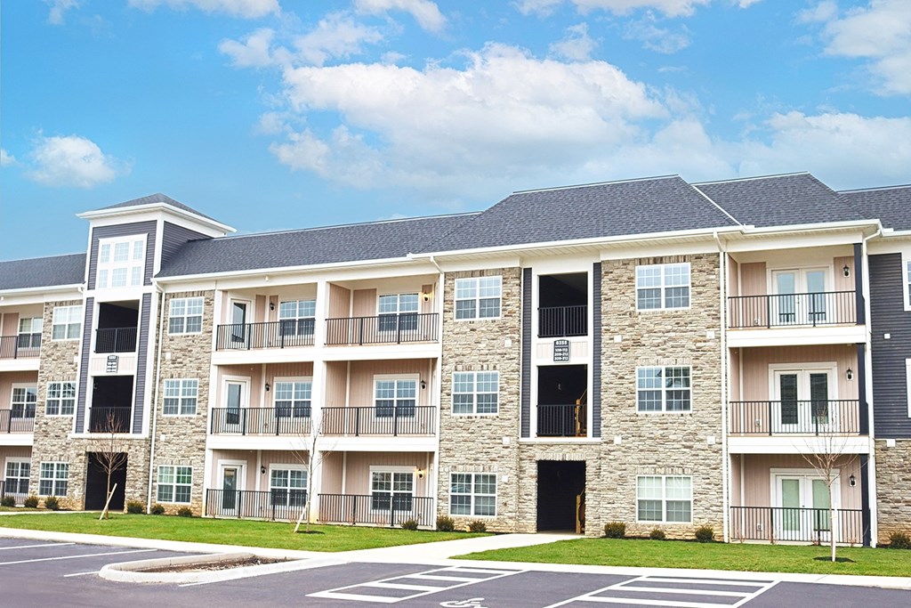 an image of an apartment building with a parking lot