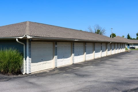 a building with white garage doors and a parking lot