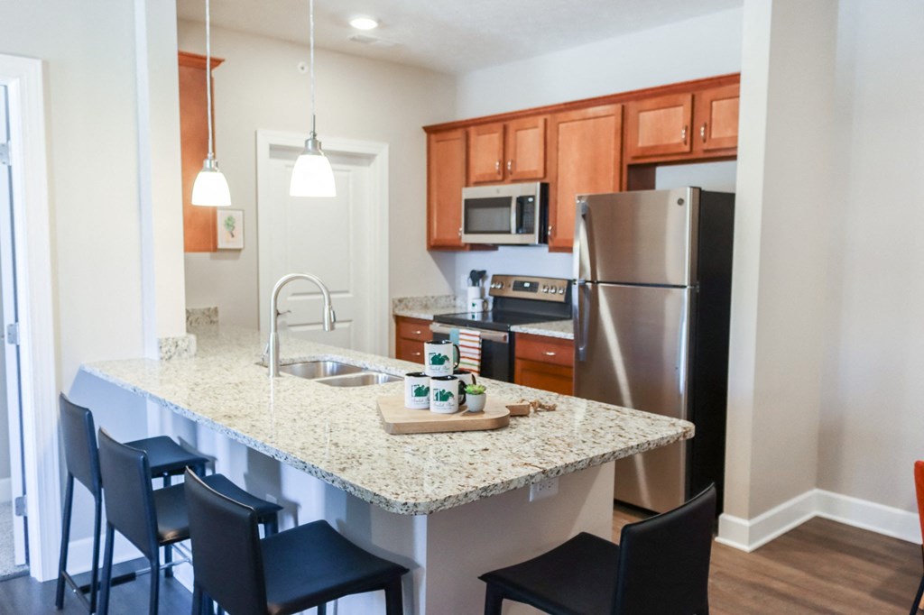 a kitchen with a granite counter top and stainless steel appliances